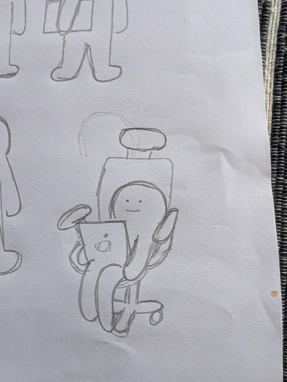 The engineer in an office chair, laptop on his knees.